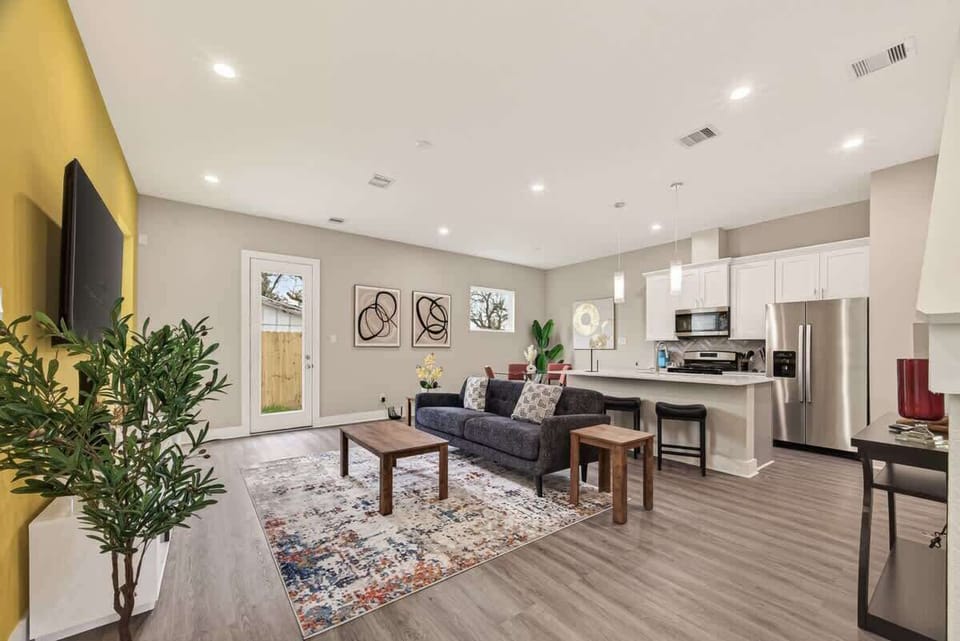 Living Room: Bright space with vibrant accent wall, modern furnishings, and perfect for gatherings!