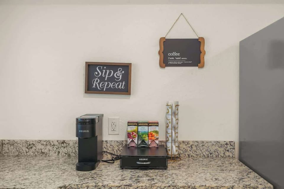 Premium coffee station stocked with drip coffee maker, Keurig, premium coffee and tea selections, creamers, sugars, and sweeteners — the perfect morning setup for relaxing before Disney adventures or sports tournaments in Kissimmee.