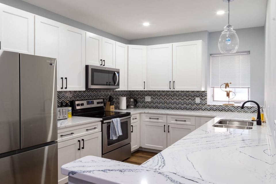 Beautifully renovated kitchen with all new stainless steel appliances and gorgeous quartz countertops