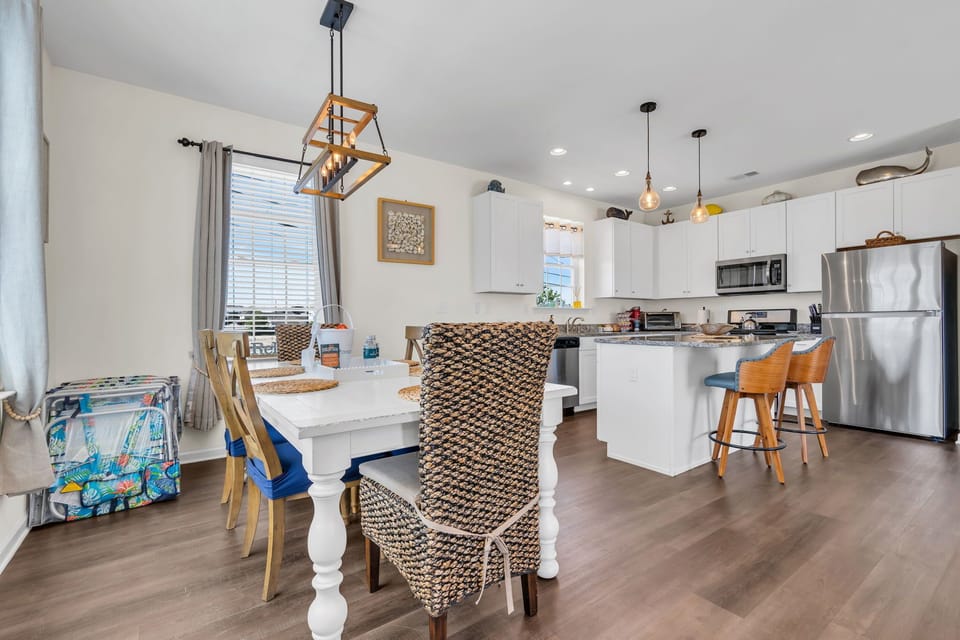 Bright open kitchen and dining area with island seating and modern finishes
