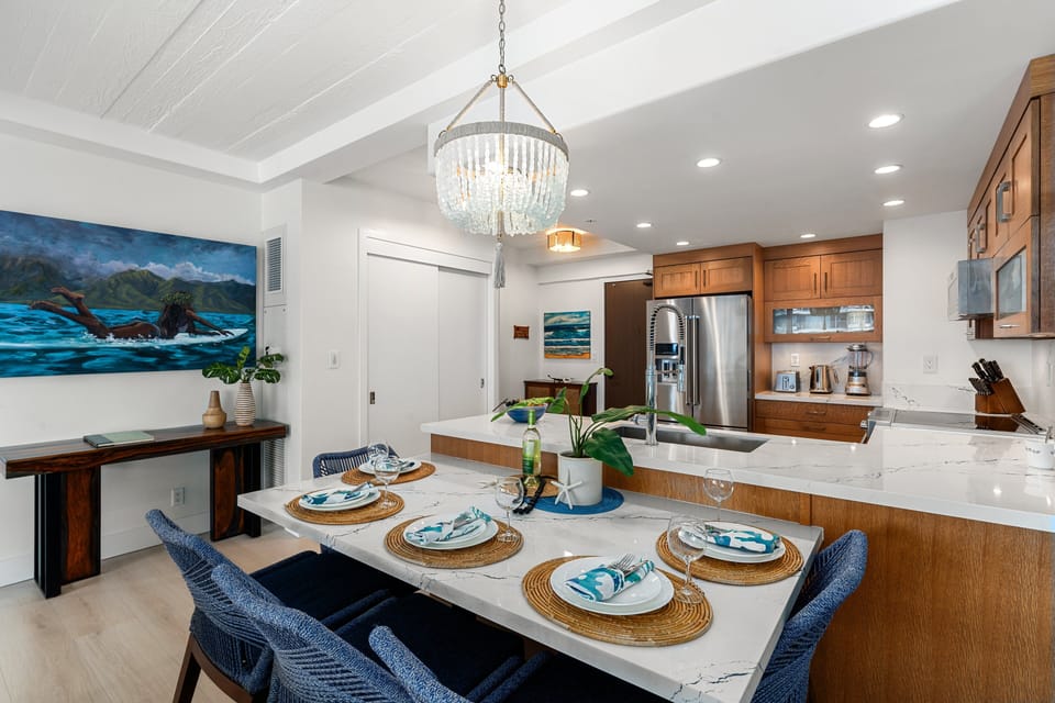 Spacious dining area connected to a modern kitchen with island seating and premium finishes.