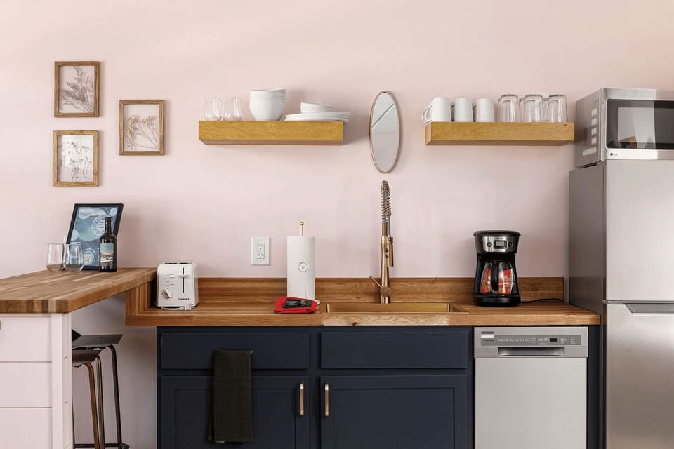 Convenient kitchenette with dishware, coffee maker, mini fridge, microwave, and dishwasher for easy meals during your stay.