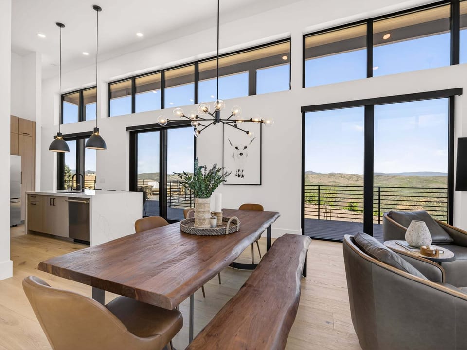 Just off the kitchen is a beautiful custom live edge solid wood table with chairs and bench seating for 8+ as well as 4 barstool seats at the island.