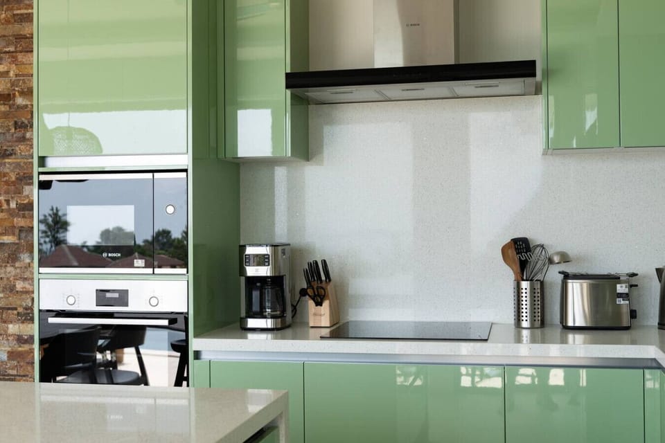 Kitchen detail with built-in oven, coffee machine and premium appliances