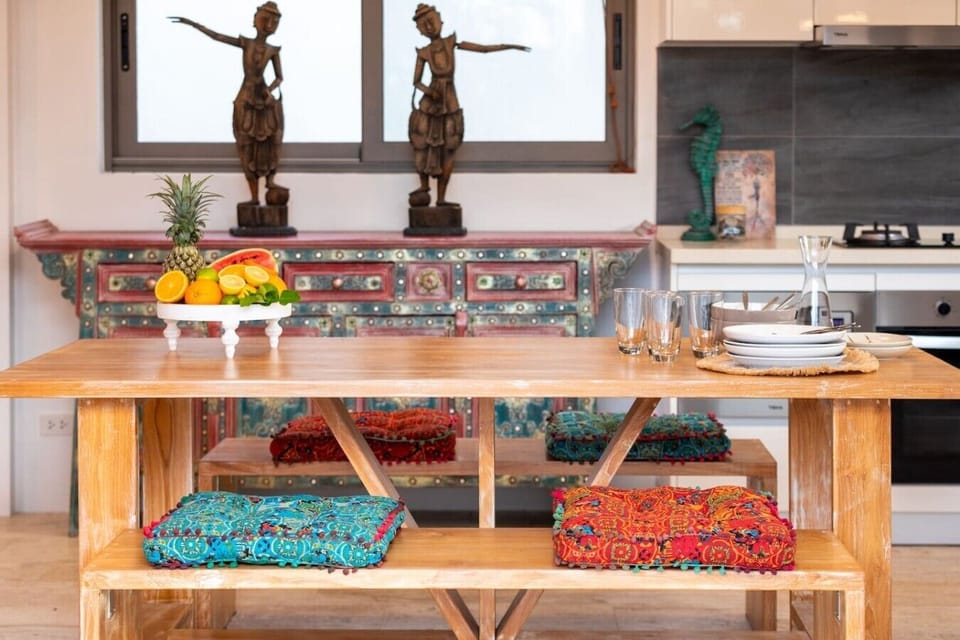 Handcrafted Balinese Dining Table with Colorful Cushioned Bench & Wooden Sculptures