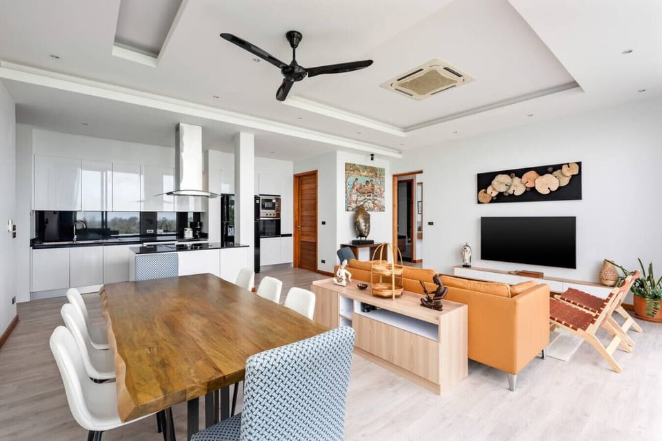 Open-plan living area with ceiling fan and panoramic sea views at Villa Ombra, Koh Samui