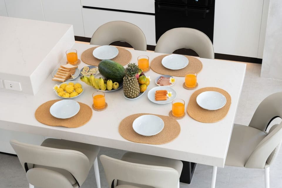 Delightful poolside breakfast setup with fresh tropical fruits and morning coffee
