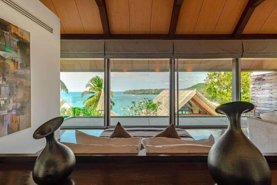 Warm timber-accented living space with sea views at luxury Surin Beach villa in Phuket