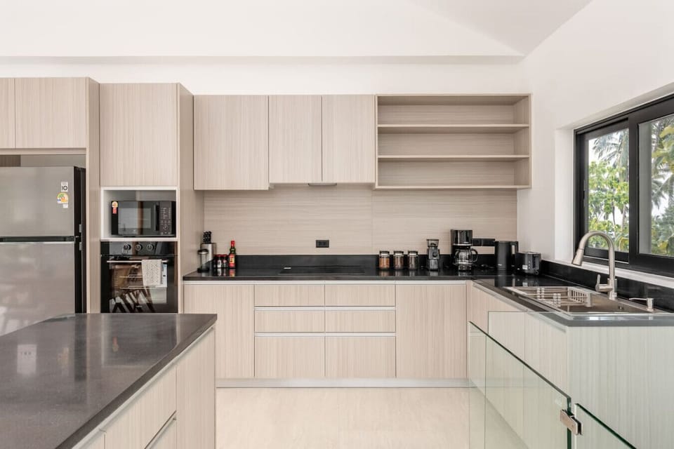 Entertainment lounge with natural stone feature wall and modern furnishings, Koh Samui villa