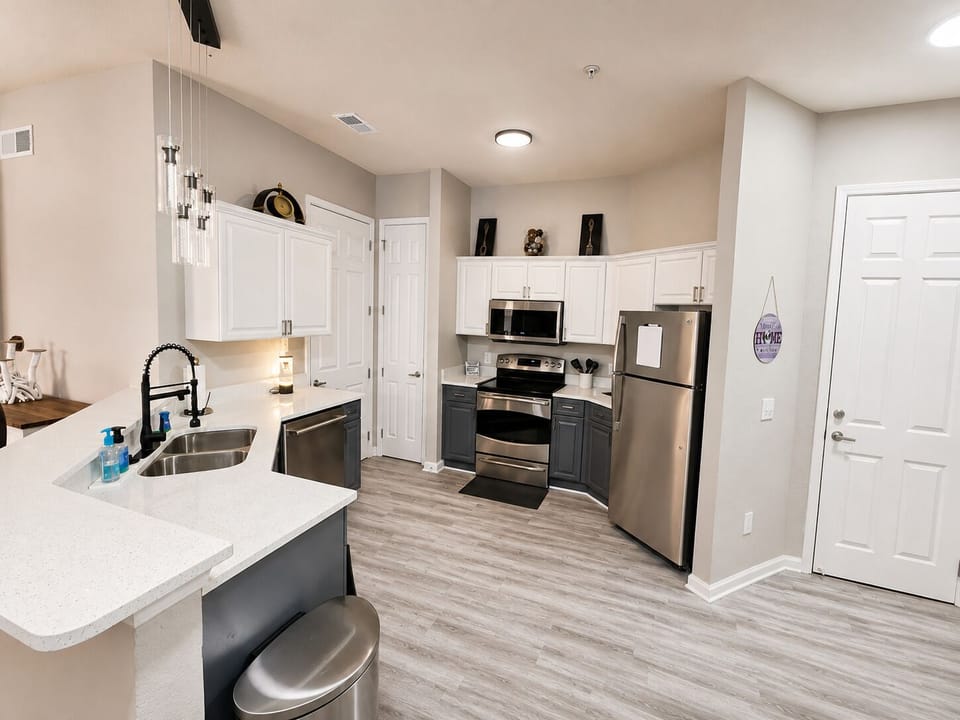 Spacious kitchen with pots, pans, glasses, coffee cups, plates, utensils, etc)