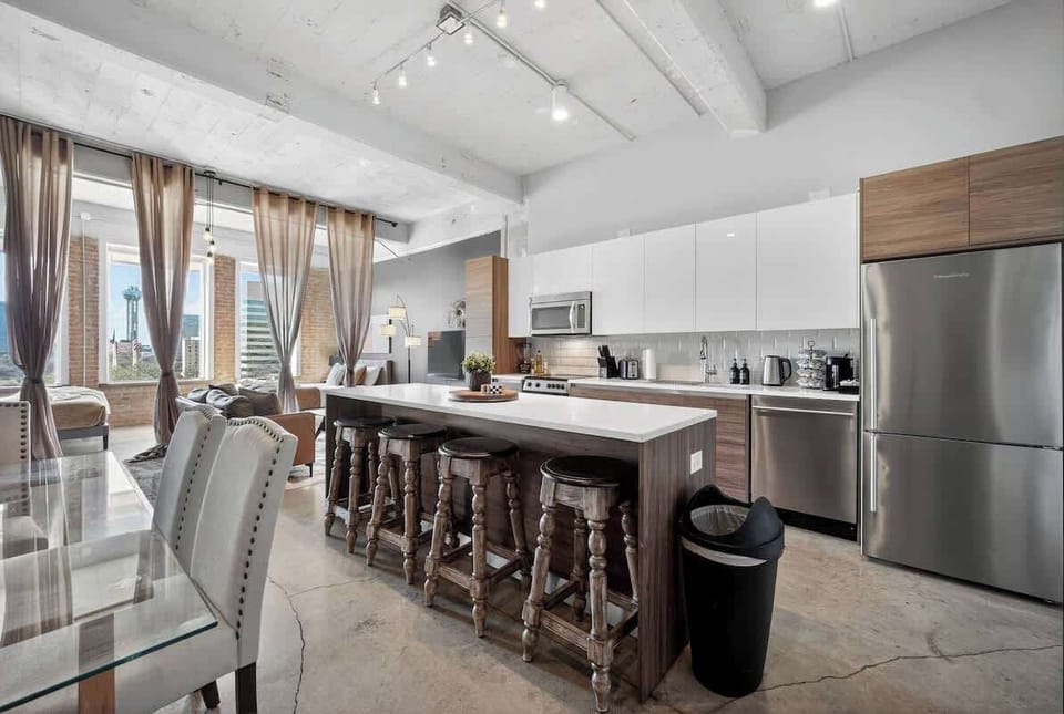 Large kitchen island seats your entire group - from morning coffee before conventions to late-night takeout after exploring Deep Ellum.