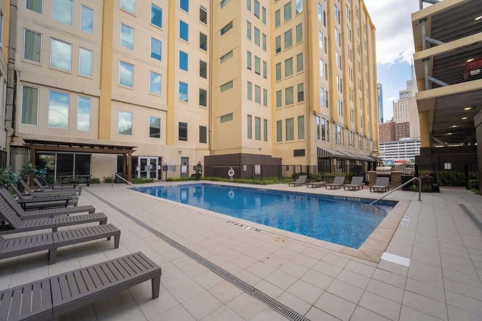 Poolside relaxation steps from your loft - seasonal outdoor pool for families staying at Butler Brothers Building downtown.