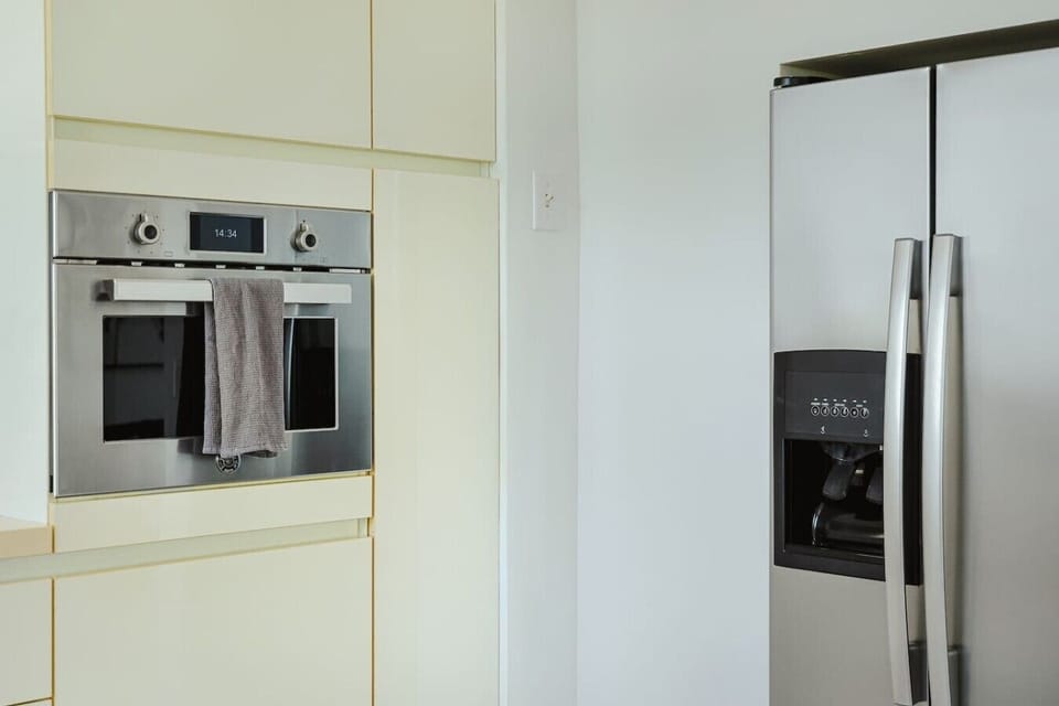 Fully equipped kitchen featuring modern appliances, cookware, essentials, and ample space for meal preparation.