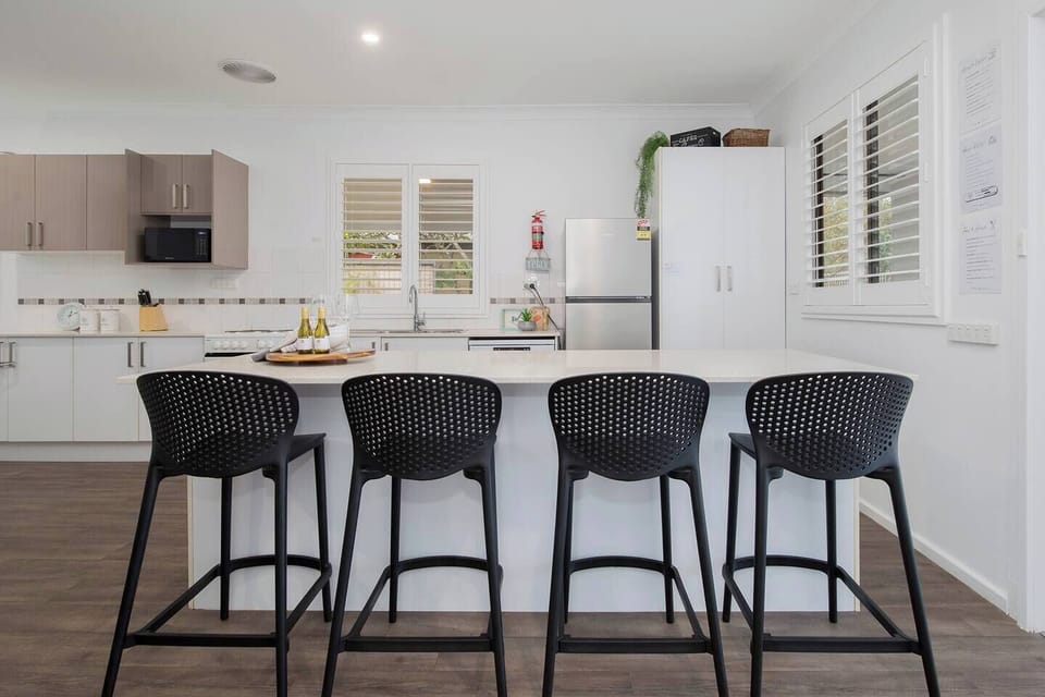 Start the day with coffee at the oversized island bench or pull up a stool for relaxed conversation while meals come together in the heart of the home.