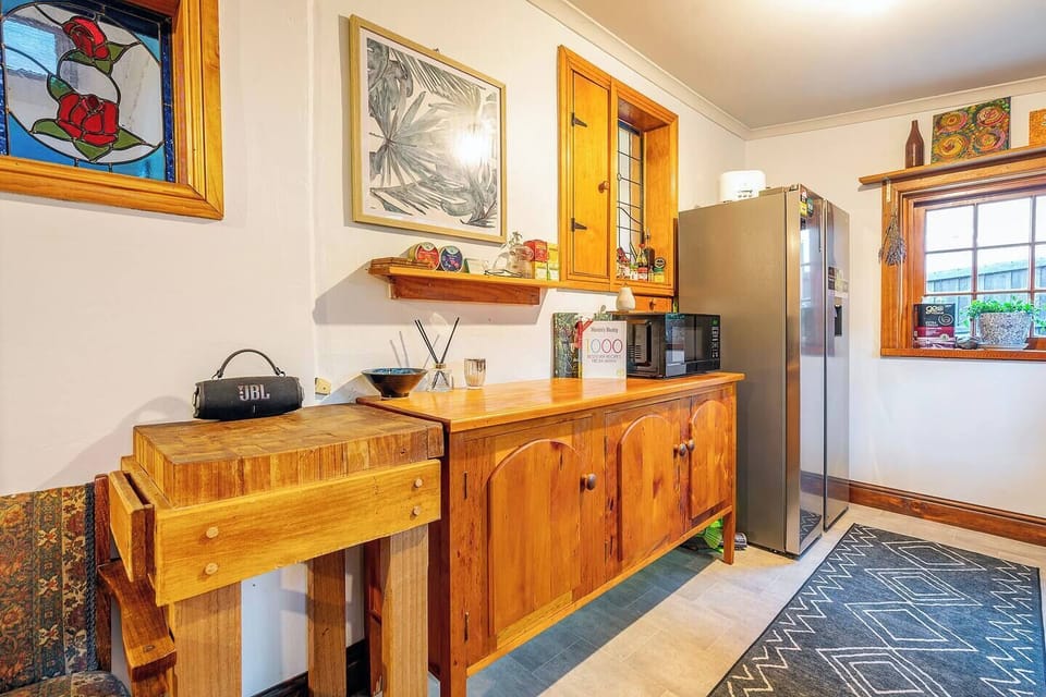 The kitchen blends vintage charm with modern convenience, making it easy to prepare meals while enjoying the home's timeless character.