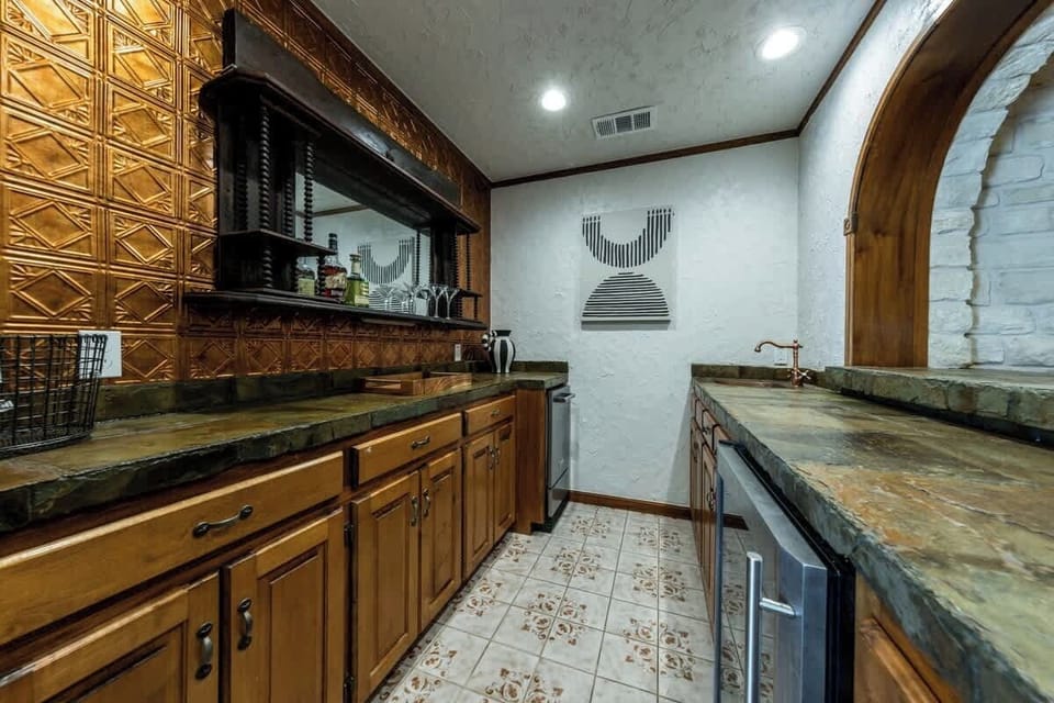 Off the hallway is a wet bar area, equipped with a sink, ice maker, wine fridge, and drink prep area. The bar has plenty of space for guests to make all their favorite cocktails.
| 9T Ranch by Boutiq Luxury Vacation Rentals | Gonzales, Texas