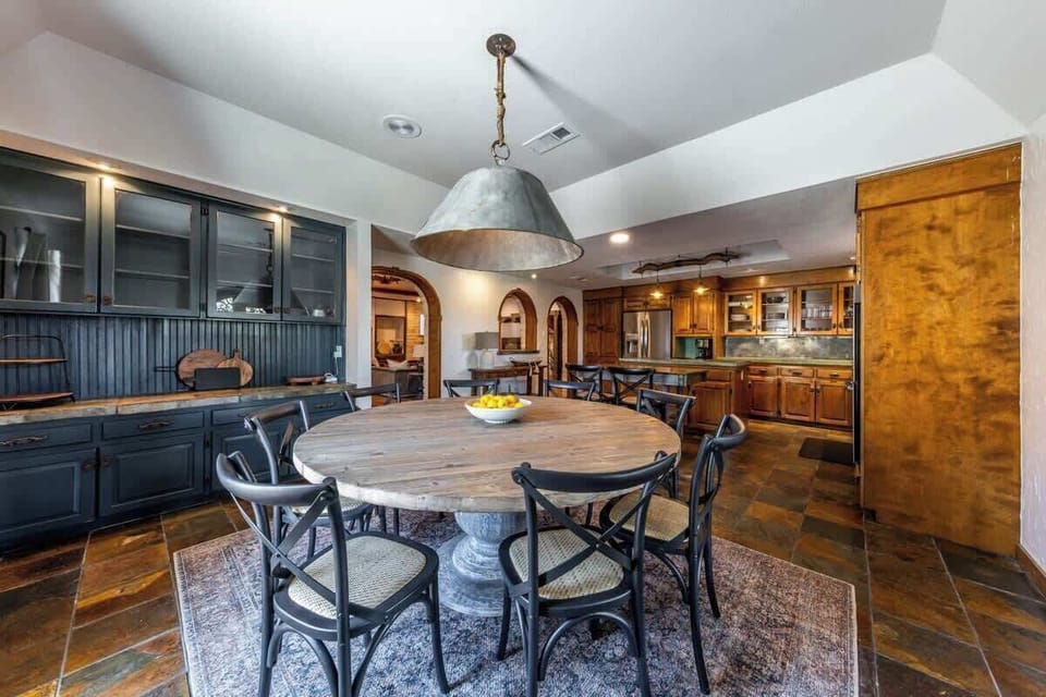 Large circular family dining table adjacent to the kitchen prep area so meals are a breeze and family engagement maximized.
| 9T Ranch by Boutiq Luxury Vacation Rentals | Gonzales, Texas