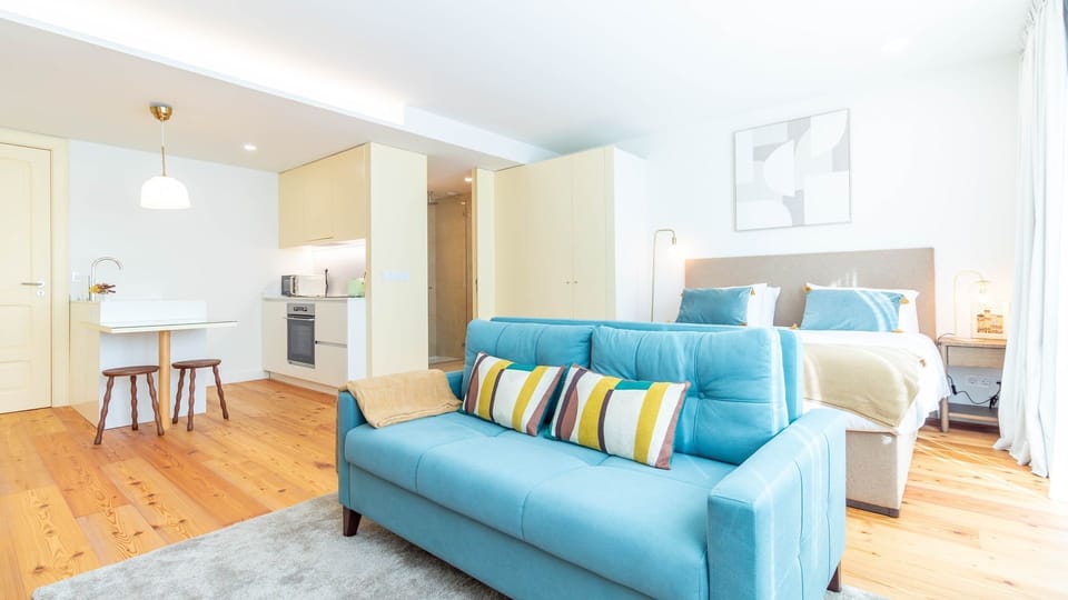 Open-plan living with curated interiors, a plush king-size bed, and a cosy lounge corner perfect for unwinding after exploring the city. #DesignStay #BoutiqueLiving #PortugalGetaway #CityEscape