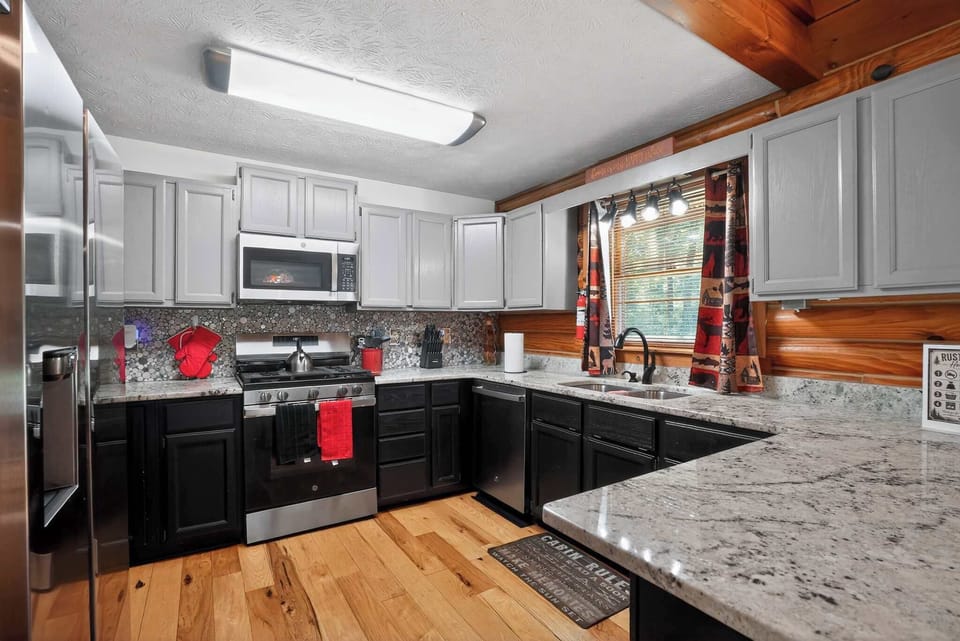 Cook meals with ease in the updated kitchen featuring modern conveniences and rustic charm.