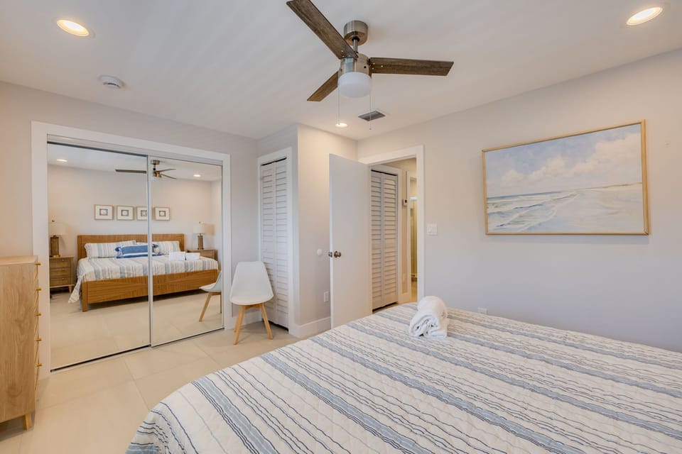 King sized bed in primary bedroom overlooking peaceful canal
