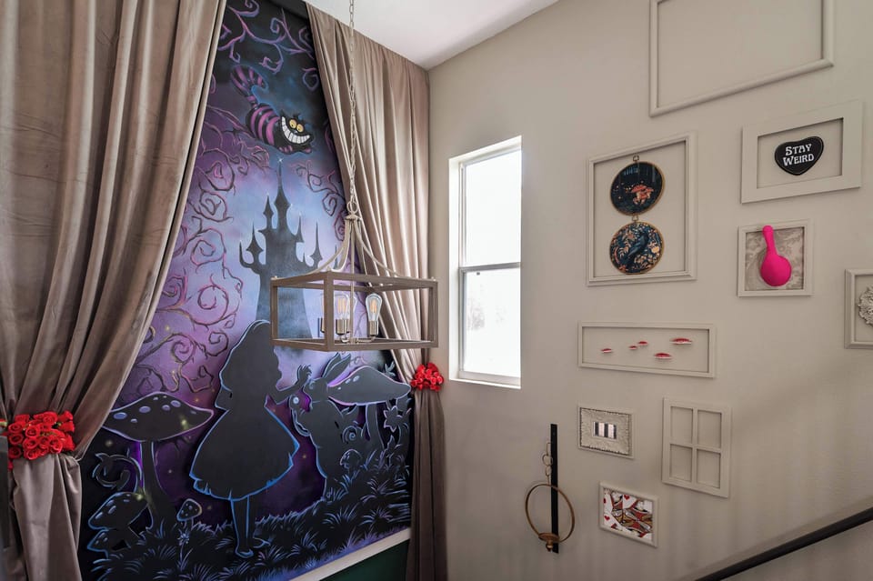 A whimsical wall mural inspired by alice in wonderland adds a playful touch to the stairwell.