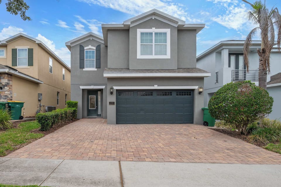 Modern two-story home with a spacious driveway and attached garage.