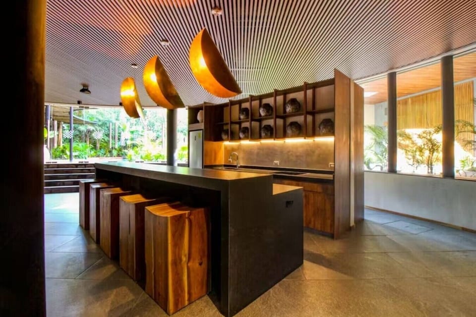 Elegant shared kitchen and bar area with warm lighting, modern finishes, and the perfect setup for gathering with friends or family.