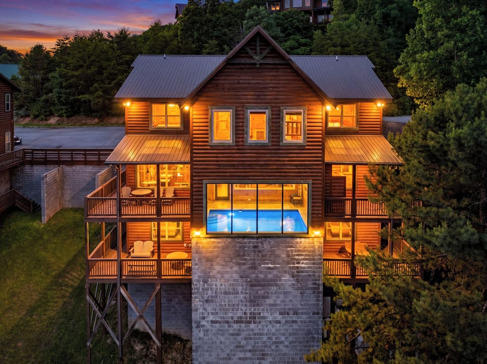 Large luxury cabin rental in Sevierville TN featuring multi-story decks, mountain surroundings, spacious parking, and premium Smoky Mountain