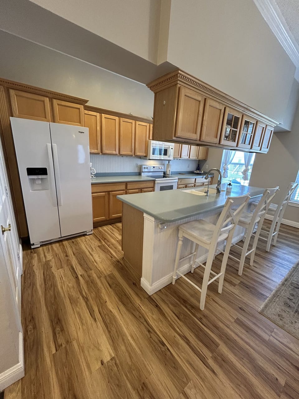 Fully equipped kitchen with everything you need for meal prep and family dinners. Features include full-size appliances, ample counter space, abundant cabinet storage, and a convenient breakfast bar with seating.