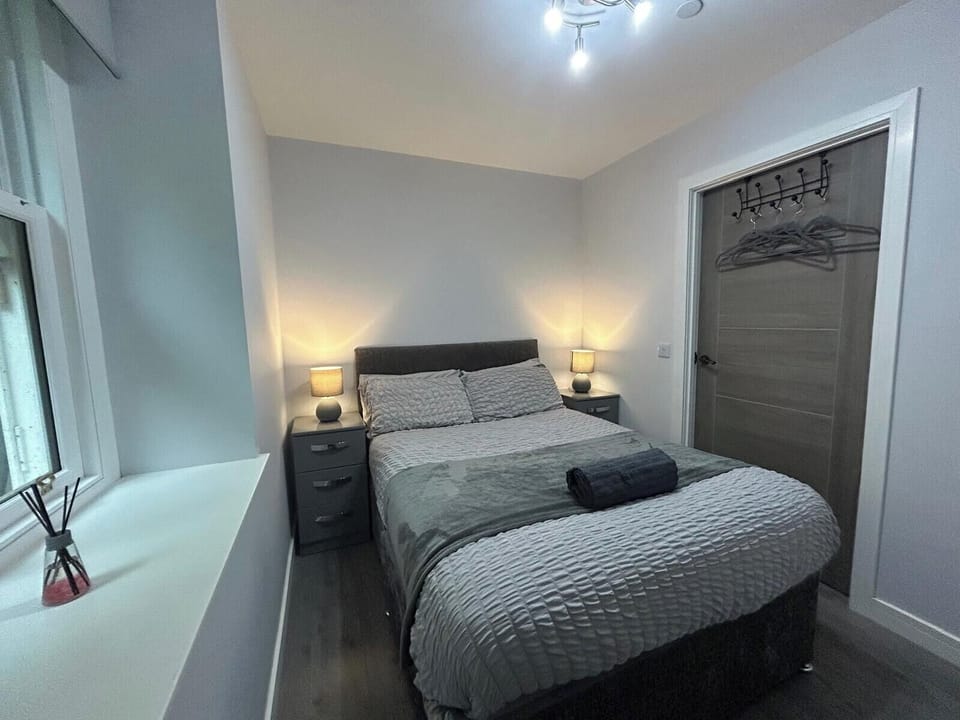 Second double bedroom with smart TV and hanging storage