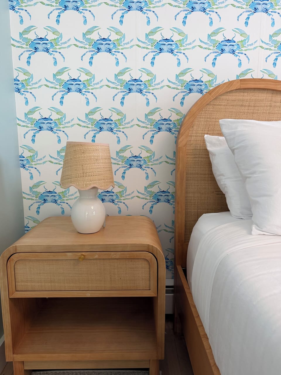A whimsical coastal retreat with cheerful crab wallpaper and natural textures
