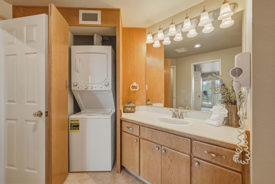 Shared ensuite with shower/tub combo, and laundry area, accessible from the living area 
