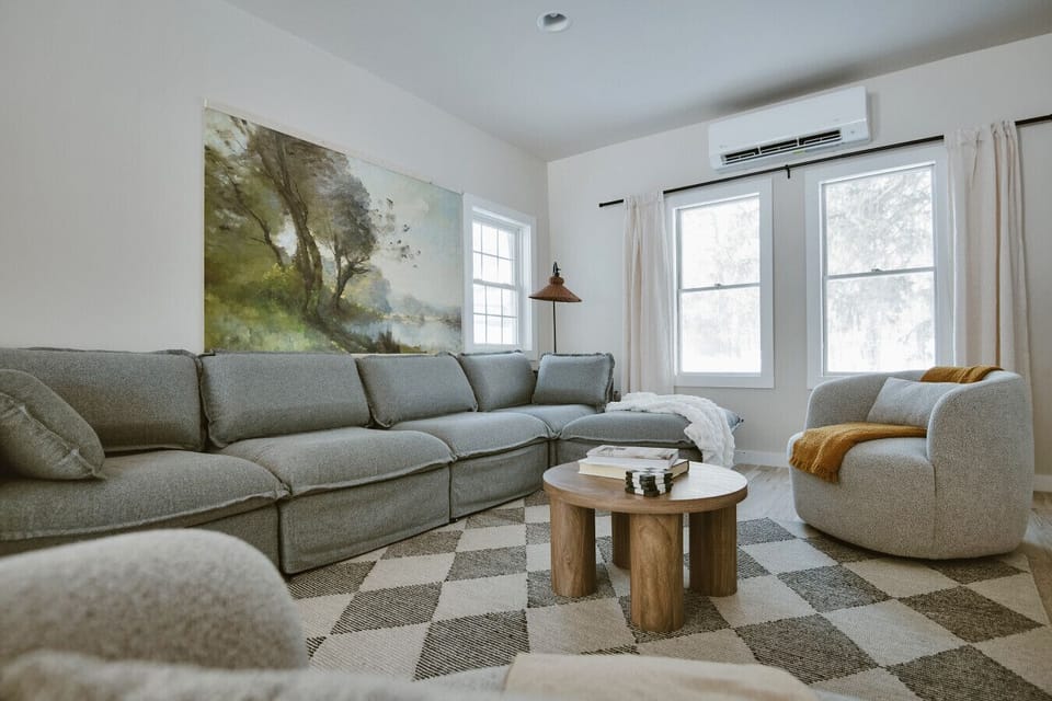 Cozy living room with oversized seating and warm natural light.