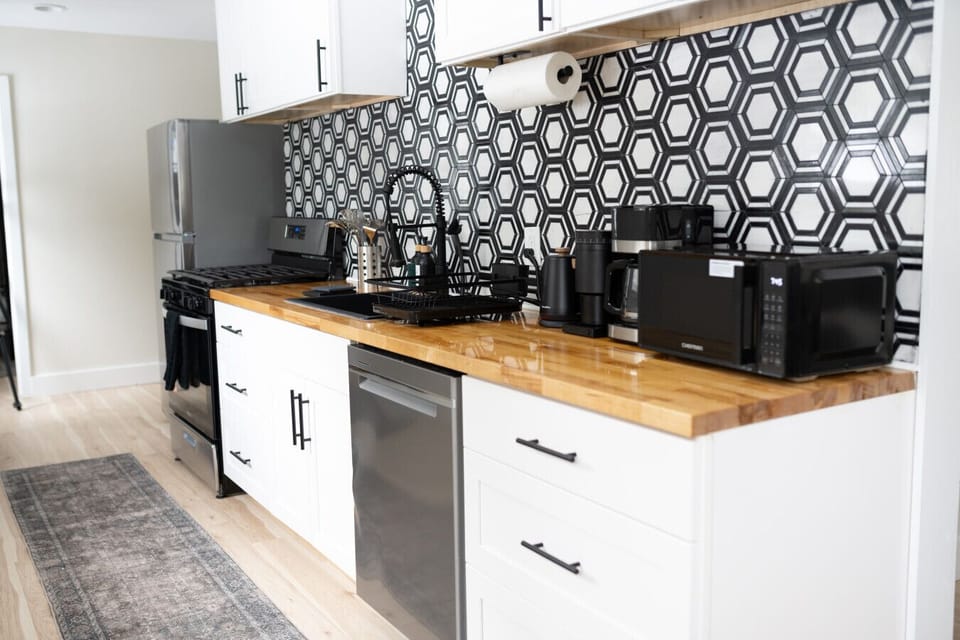 Kitchen: Enjoy culinary adventures in this stylish kitchen with modern appliances and sleek decor!