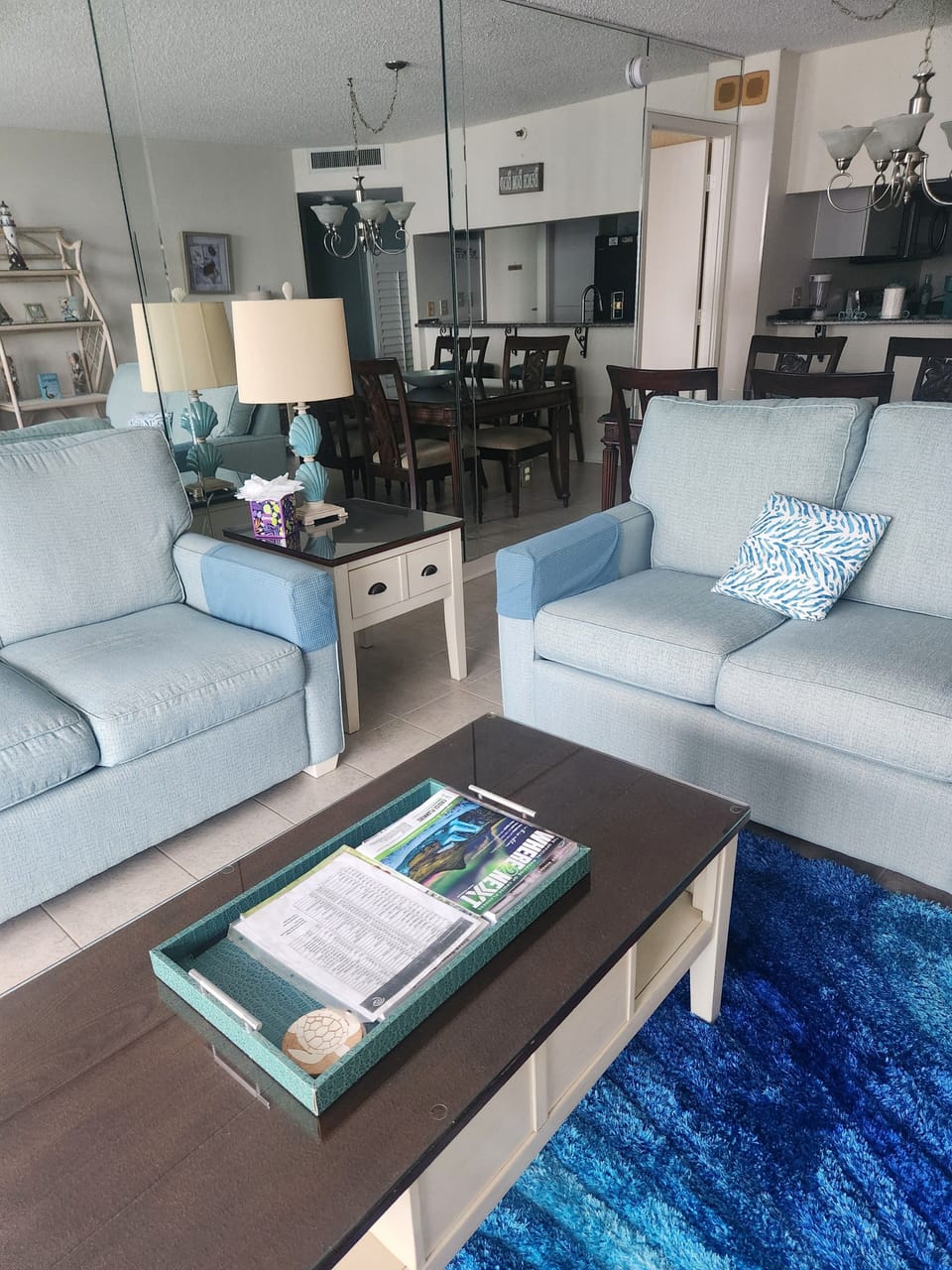 Sofa & loveseat.   Dining area behind loveseat.  Mirrored wall which reflects the ocean when drapes are open!