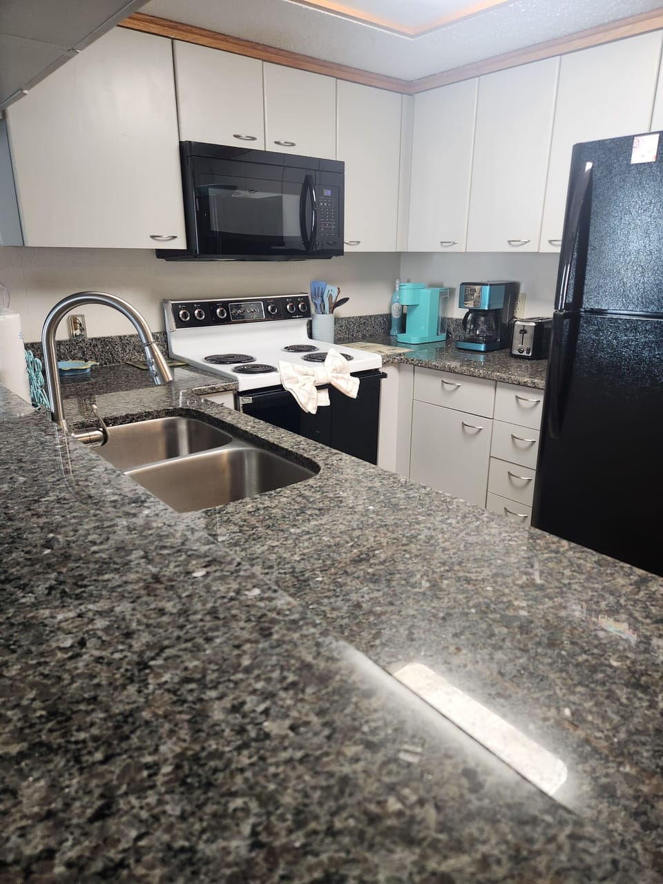 Full kitchen with Dishwasher, fridge, stove,  coffee pot and keurig.
