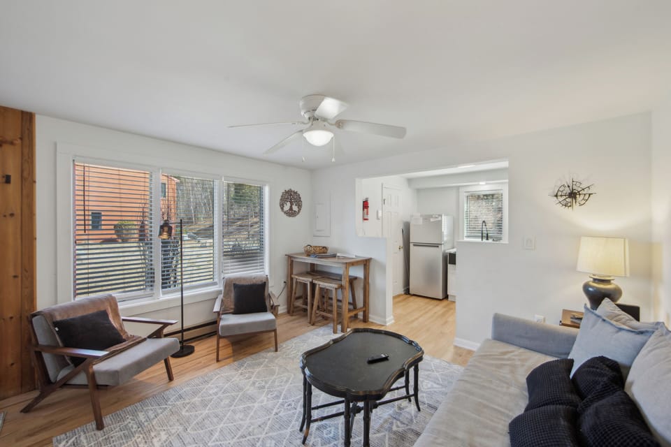 Bright dining and living layout with oversized windows that flood the home with gorgeous natural afternoon light.