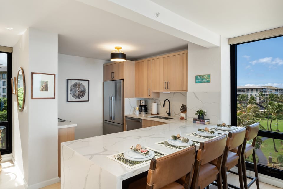 Spacious kitchen island with seating for four creates the perfect gathering spot for meals, conversation, and morning coffee.