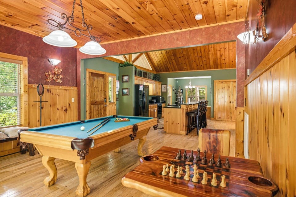 Challenge your travel companions to a game of pool or chess in this inviting space, where rustic wood meets playful comfort and every corner invites you to unwind.