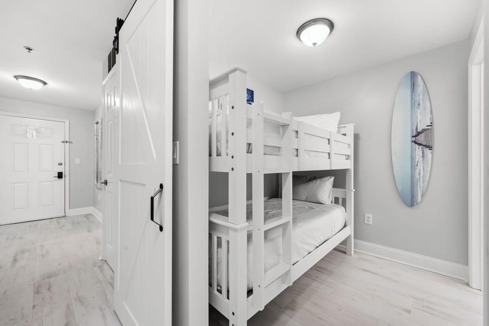 Coastal dreams come to life in this bright bedroom with beach-themed decor and comfy bunk beds—perfect for the kids to unwind after a day of sun and sand.
