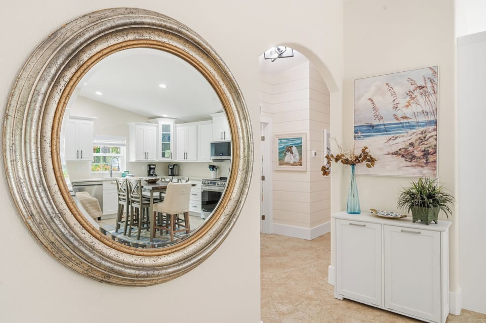Step through welcoming archways into a bright, coastal-inspired home where beachy artwork and thoughtful décor invite you to unwind from the moment you arrive.