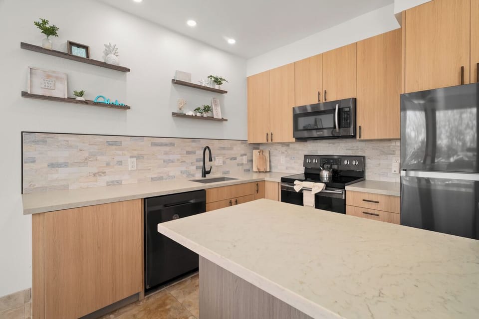 Your own modern kitchen awaits, with sleek cabinetry, a spacious island for meal prep, and tasteful decor that makes cooking feel effortless and inspiring.