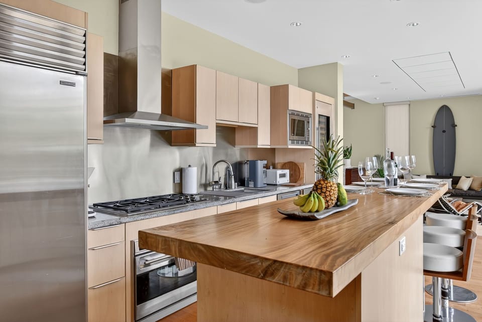 Prepare meals with ease at the spacious kitchen island, surrounded by custom finishes and natural light.