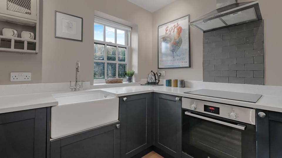 The kitchen combines a traditional farmhouse feel with a contemporary elegance.
