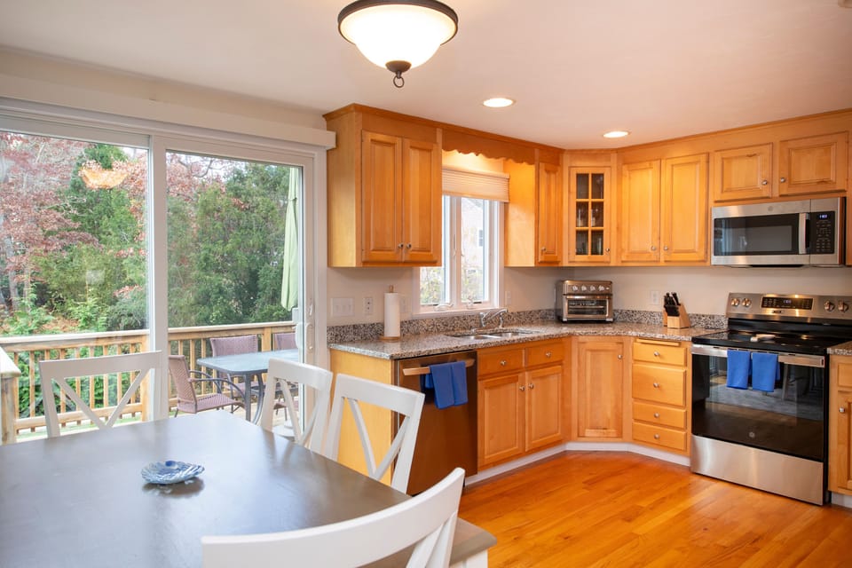 Step into a cozy dining area where meals are enjoyed with natural light and views of the serene outdoor patio.