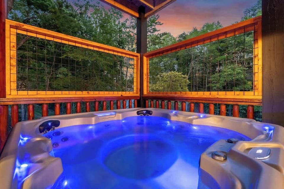 Private hot tub with forest views and cozy evening ambiance