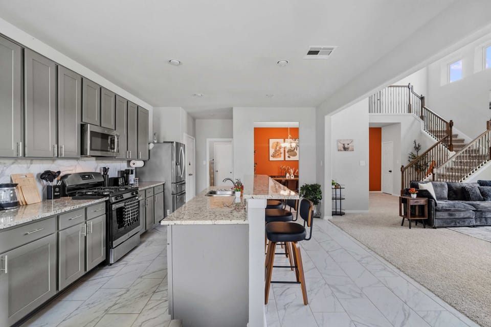 [Kitchen] The open kitchen flows seamlessly into the living space, making it easy to cook, dine, and gather together.