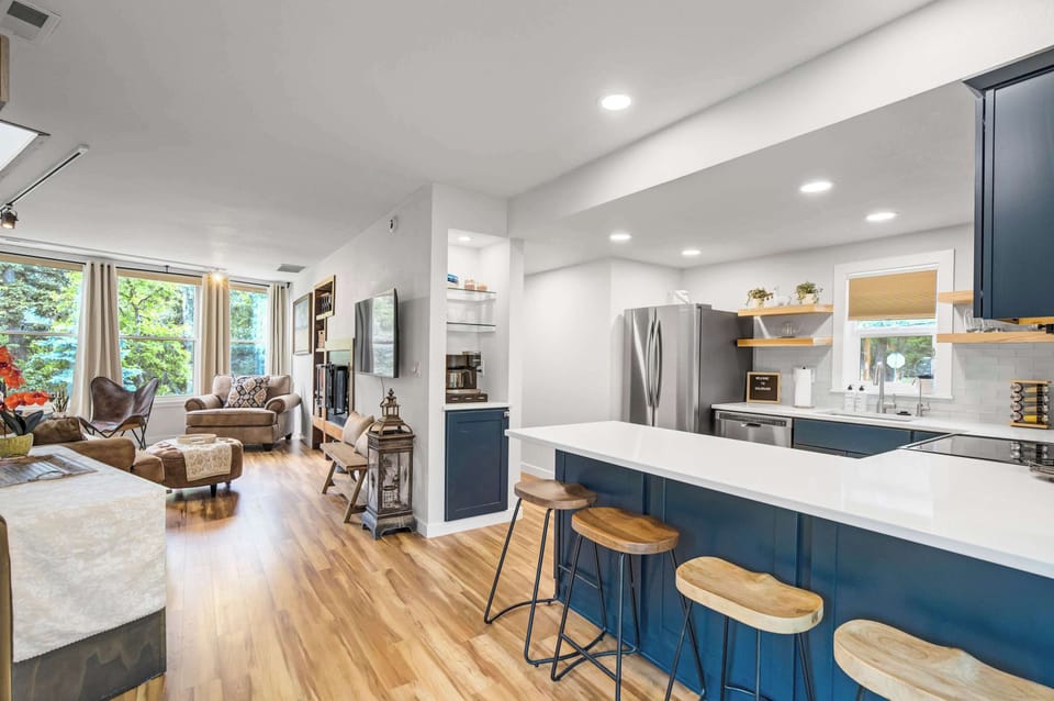
Bold navy cabinetry, white quartz countertops, and a subway tile backsplash make a striking first impression, while the peninsula with seating for four invites guests to pull up a stool and stay awhile.