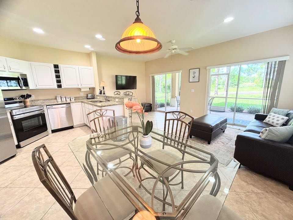 Open-concept living, dining, and kitchen space with stainless steel appliances, granite countertops, and plenty of natural light.