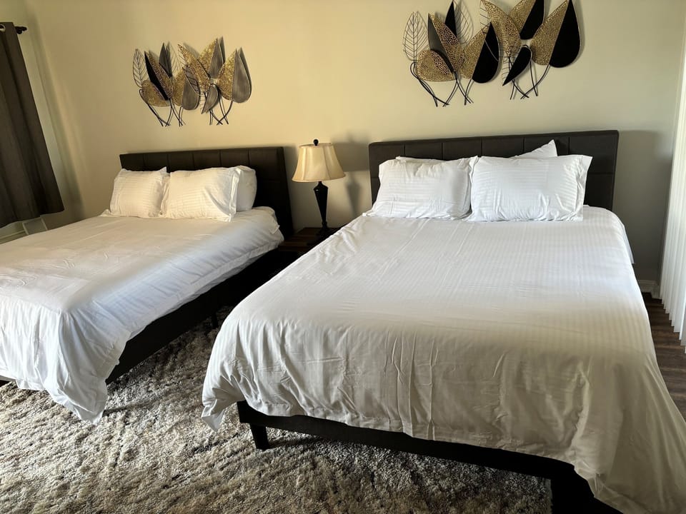Spacious bedroom with two beds, bedside lighting, and a relaxed, welcoming layout.